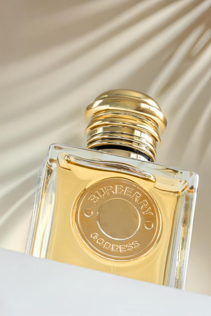 Commercial product photography featuring Burberry Goddess perfume in a premium studio-style setting.
