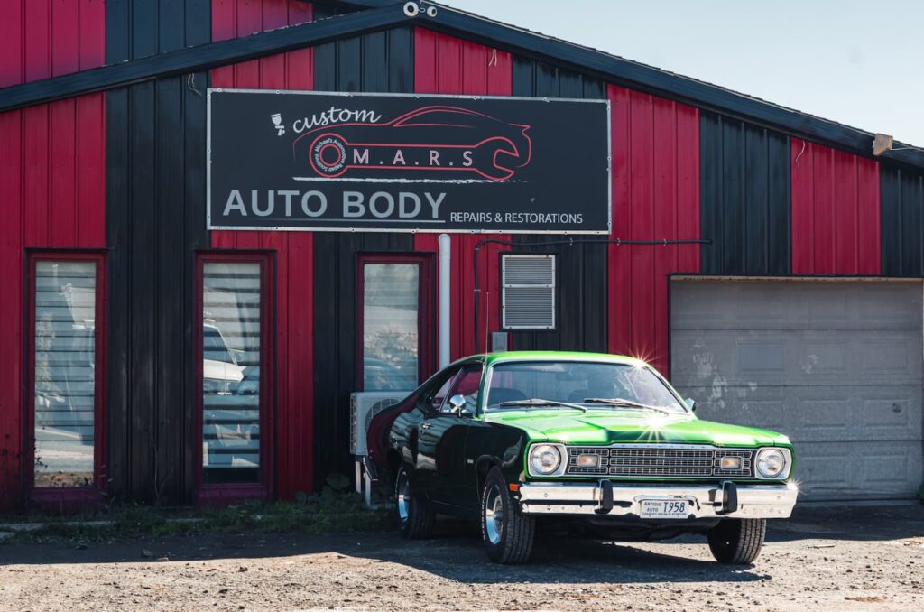 Vintage American muscle car photographed outside a restoration garage in Nova Scotia.