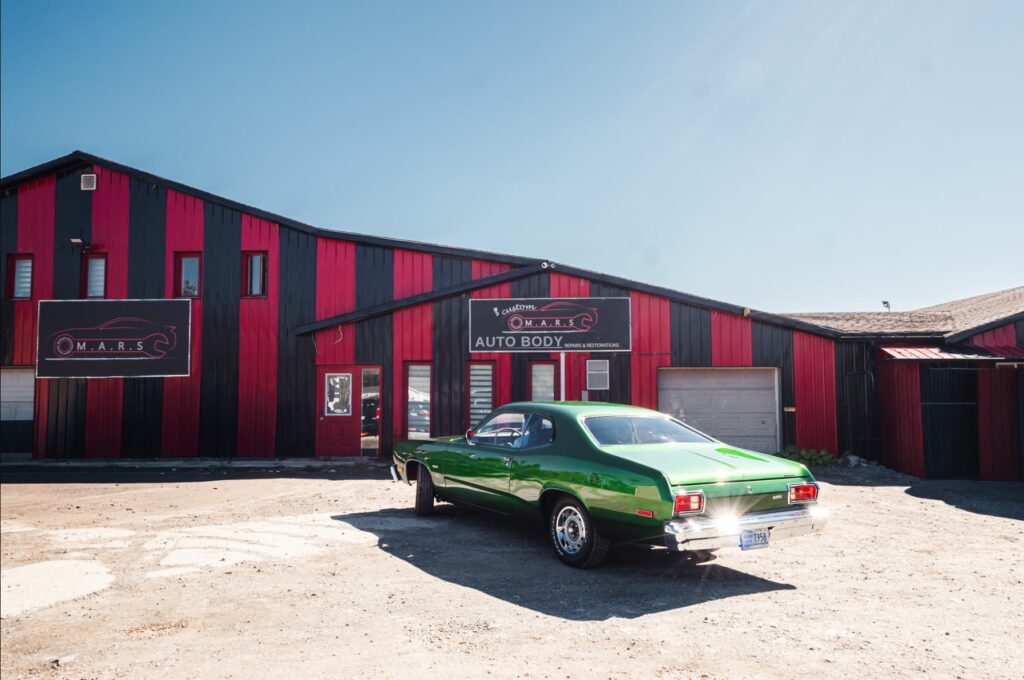 Classic green muscle car photographed outside an automotive restoration shop in Halifax, Nova Scotia.