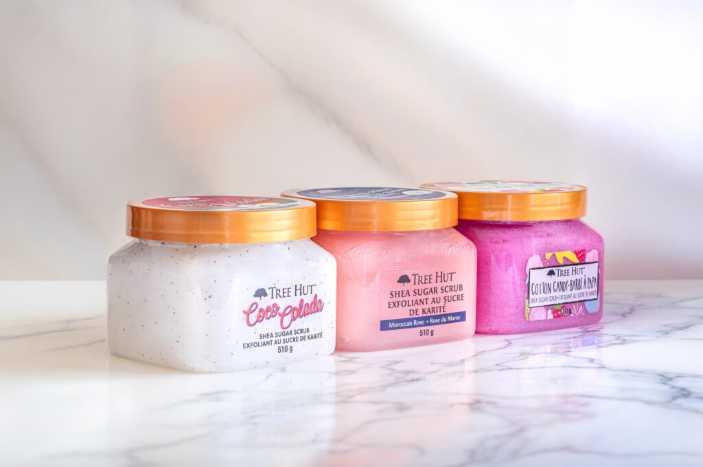 Three Tree Hut body scrubs arranged for professional commercial product photography with clean studio lighting and marble