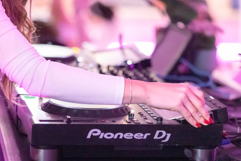 Close-up of a DJ mixing music on Pioneer decks at a Pangea Pilates event in Montreal.